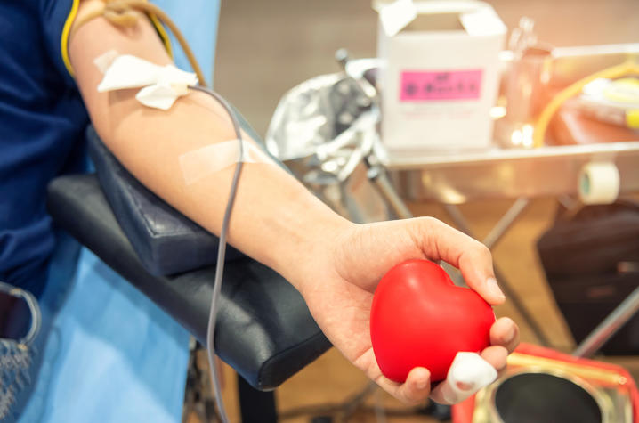 photo of person's arm while donating blood