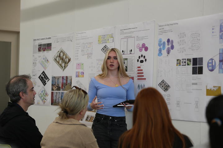  In:Access Studio Student Sydney Weibl presents her recommendations on how to make pathways in the Gray Design Building more accessible to an audience of peers, faculty and professionals during final reviews. Photo by Haley Simpkins. 