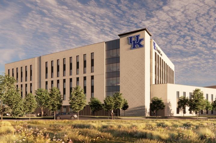 Architectural rendering of a large, modern University of Kentucky building viewed from across a landscaped lawn.