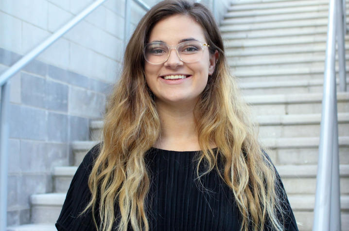 photo of Hannah Scinta in front of stairs at Student Center