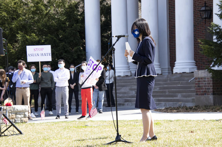 Haoying Sun at microphone in front of Memorial Hall