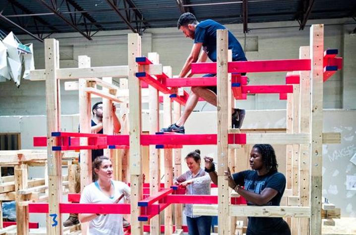 photo of architecture students working on tower for Moontower Music Festival