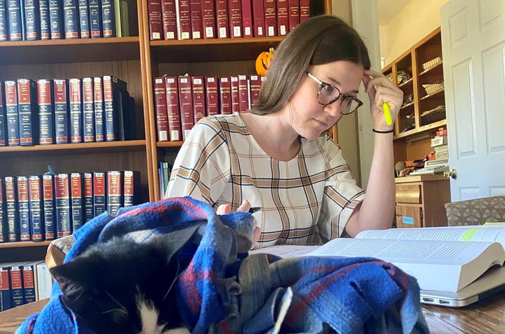 Law Clinic student studying in the office with cat