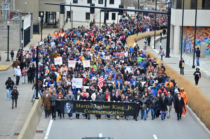 A large crowd of people participating in a Martin Luther King Jr. commemorative march in Lexington, Kentucky.