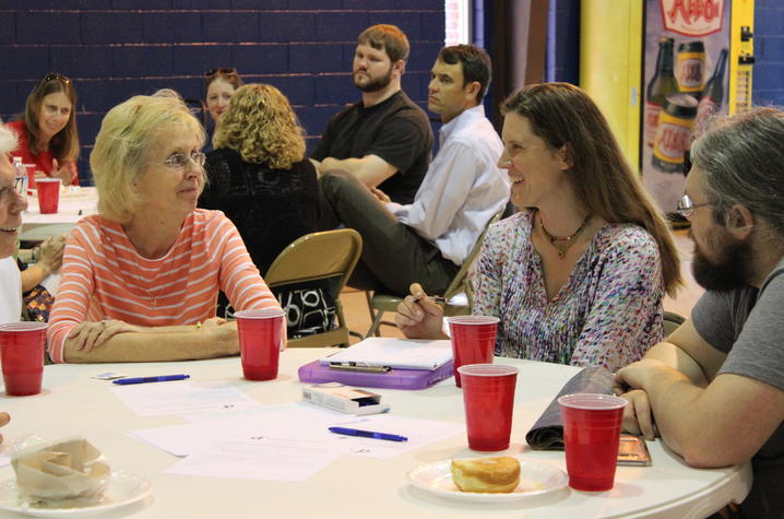 photo of student interviewing Gardenside resident at community event with HP Hybrid Field School