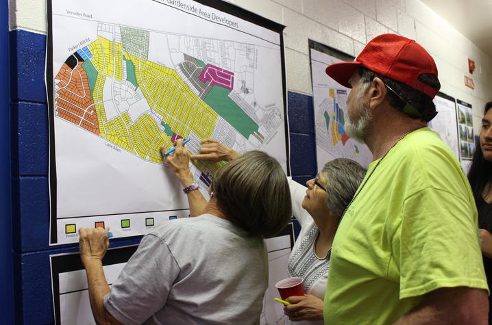 photo of Gardenside residents reviewing plans at community event with HP Hybrid Field School