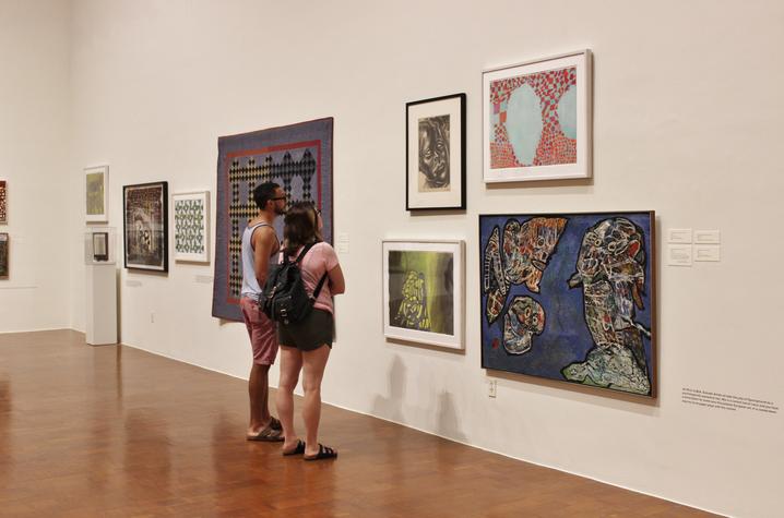 photo of visitors checking out Thomas Nozkowski exhibit at UK Art Museum