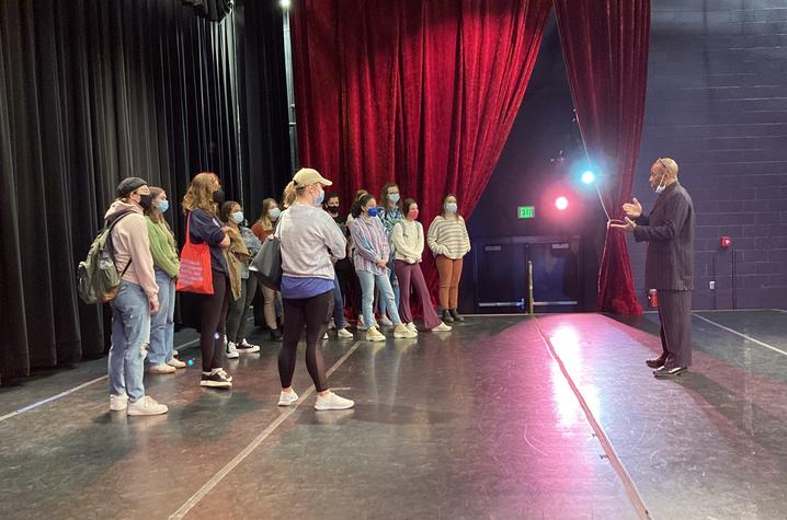 photo of Whit Whitaker (far right) talking to AAD 390 class on The Lyric stage