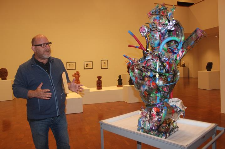 photo of Stuart Horodner discussing sculpture "Age of Discovery" by Robert Morgan