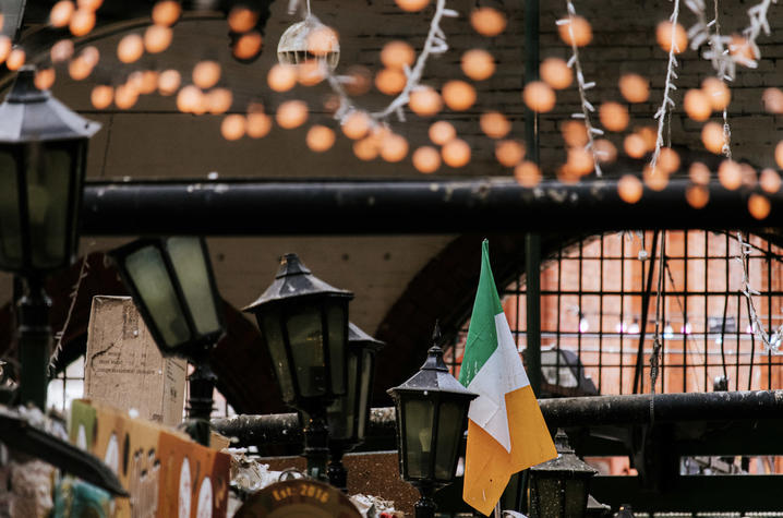 Irish flag in George’s Street Arcade. Irish flag displayed inside a covered market with hanging lights.