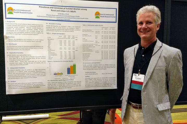 photo of Dr. Ty Borders at a poster presentation