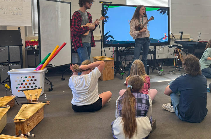 UK music students teach elementary school students basic music lessons.