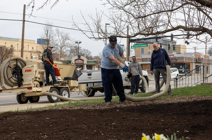 Grounds team members, from left, Jake Briden, Todd Jordan, team lead Taylor Balko and Chris Hilpp spread mulch at the Stuckert Career Center. 