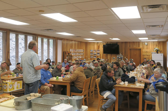 photo of Chris Barton talking with volunteers