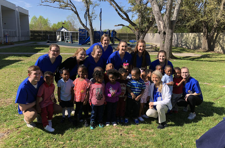 Photo of HHS 357 students with children