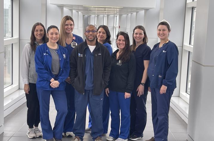 image of the lung transplant team in blue scrubs in white corridor