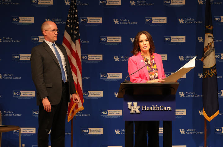 Lt. Gov. Jacqueline Coleman, right, flanked by Markey Cancer Center’s Nathan Vanderford, reads from Gov. Andy Beshear's proclamation declaring October as Cancer Education and Prevention Month. Mark Cornelison | UK Photo