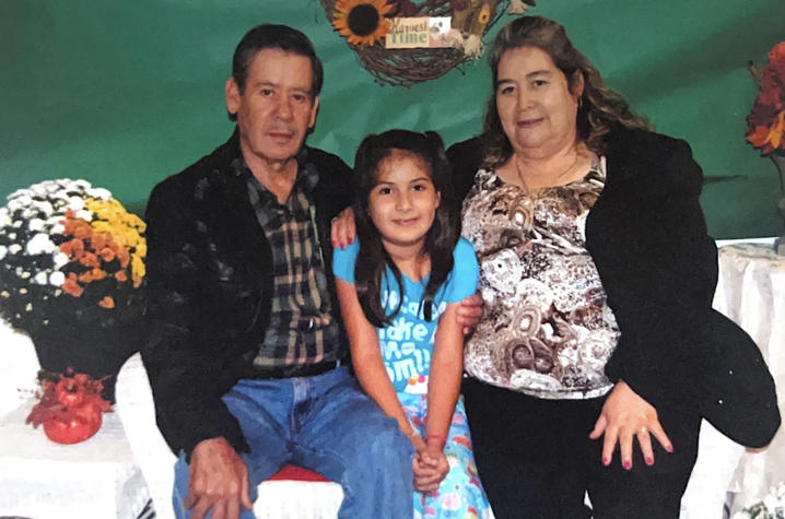 young moncerrat bravo sitting and smiling with her grandparents