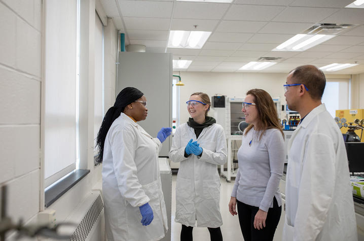 Photo of Isabel Escobar with Students in the Lab