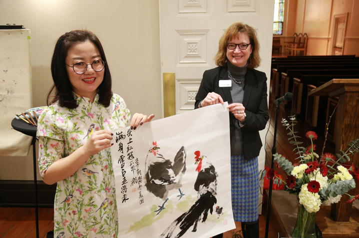 photo of Jian Li and Laura Bryan with rooster artwork at Transy Confucius Classroom 
