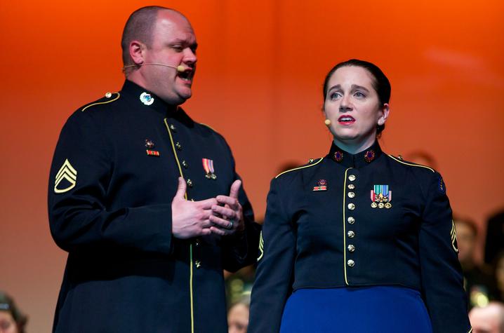 photo of Jeremy Cady and Charis Strange singing a duet in uniform