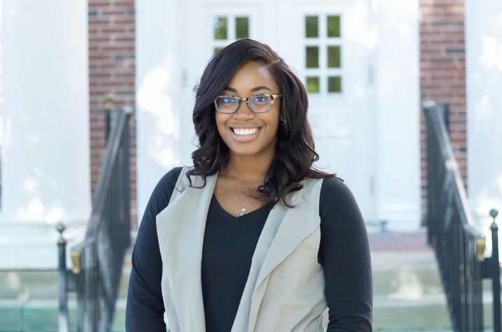 Kameron White McDaniel poses in front of the College of Education