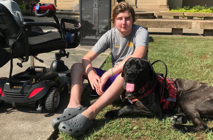 Kayne and service dog Moose on the quad at LSU