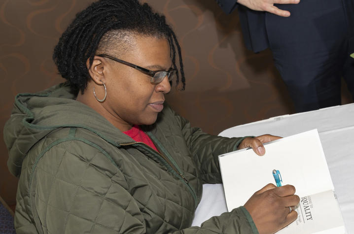 photo of author Keona K. Ervin signing book
