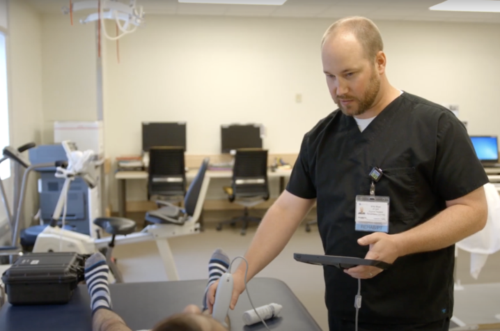 Kirby Mayer, D.P.T., Ph.D., works with a patient. 