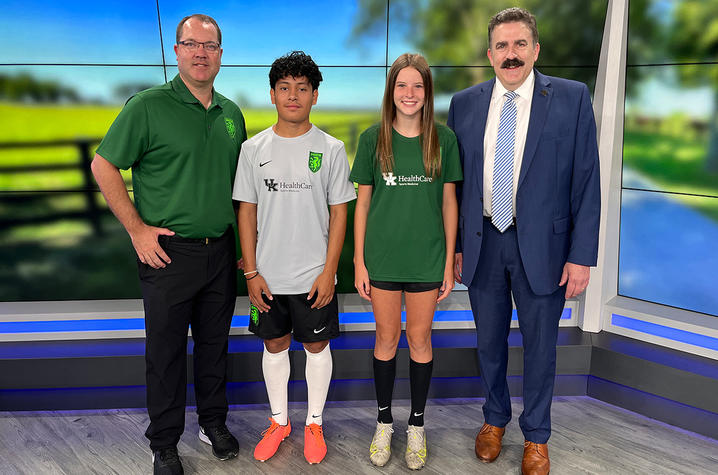 student soccer players standing together on the news