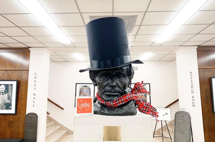 photo of Abe Lincoln bust in King Library with scarf and stovetop hat