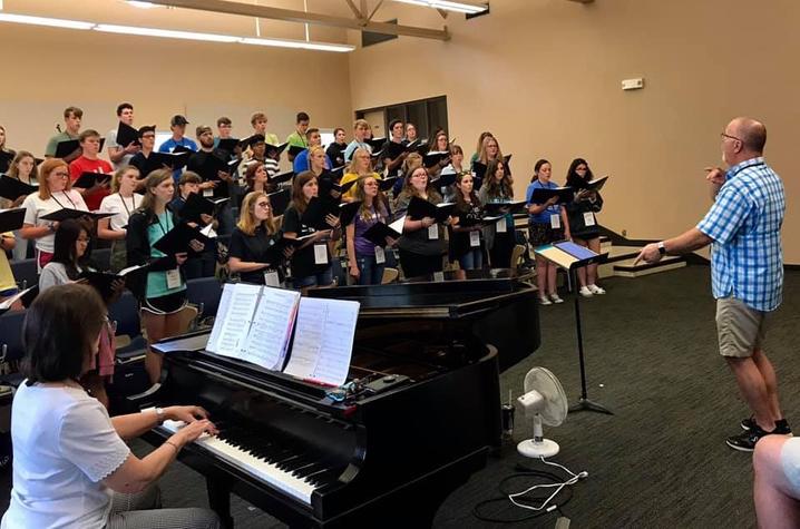 photo of Sue Ellen playing piano and Mickey Ballard directing KBC All-State Youth Choir Rehearsal