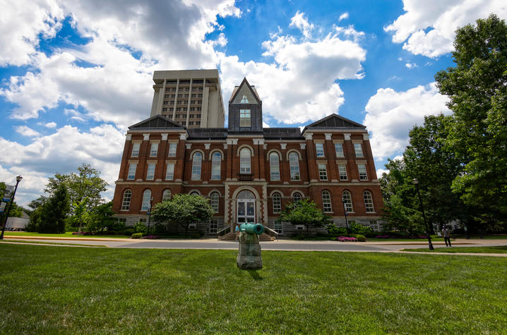 photo of UK's Main Building with puffy clouds in the blue sky