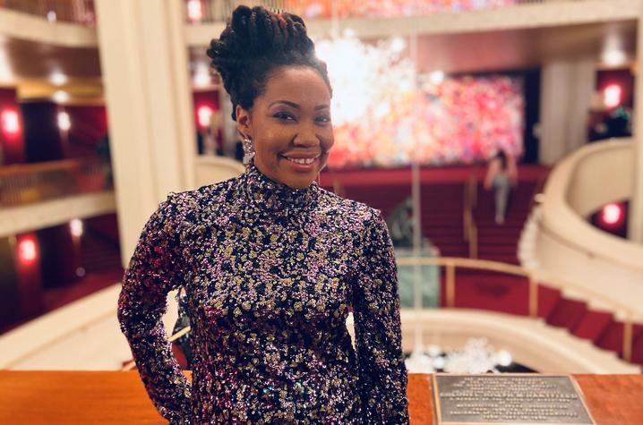 photo of Makeda Hampton inside the Met with a trademark chandelier behind her