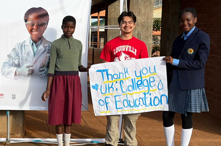 Photos of students holding sign Three students hold a sign reading “Thank You UK College of Education” beside a banner at a school.