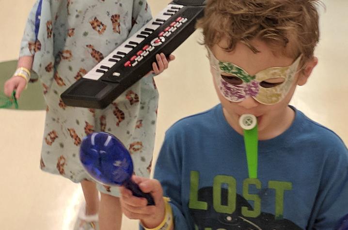 Child Life staff and nurses join the young patients in a Mardi Gras parade.