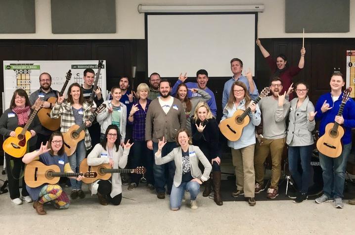 photo of participants in Modern Band Workshop holding guitars