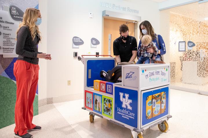 Photo of family trying out the NICU transport cart