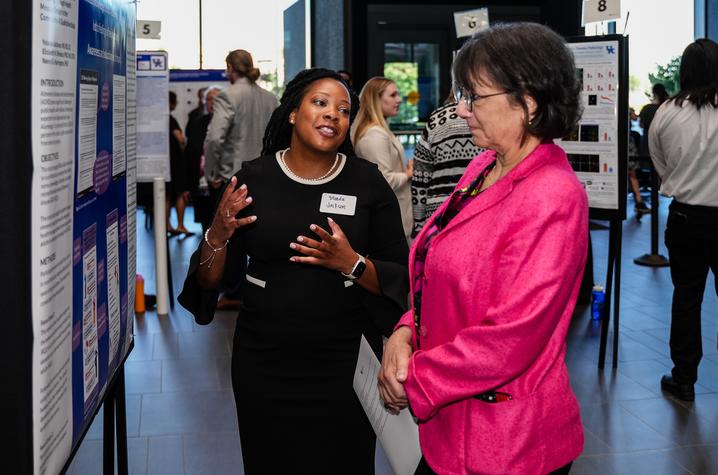 Yolanda Jackson, College of Communication and Information Ph.D. student, shares her Alzheimer’s screening research with NIH Director Monica Bertagnolli. Jeremy Blackburn, Research Communications