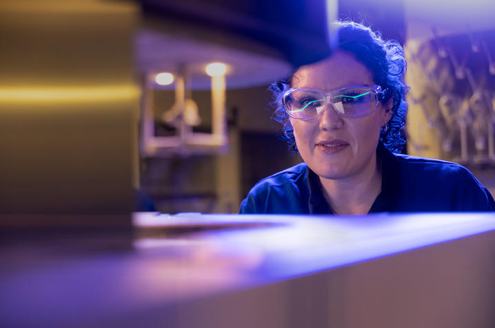 Zan Paterson is in her lab looking at a piece of equipment