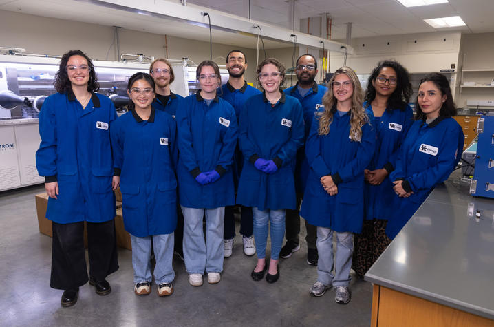 Zan Paterson (center) stands with her research team in her lab