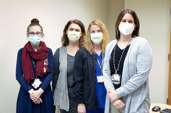 four women standing inside the uk polk-dalton clinic