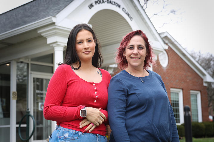 Two women standing together in front of the UK polk-dalton clinic