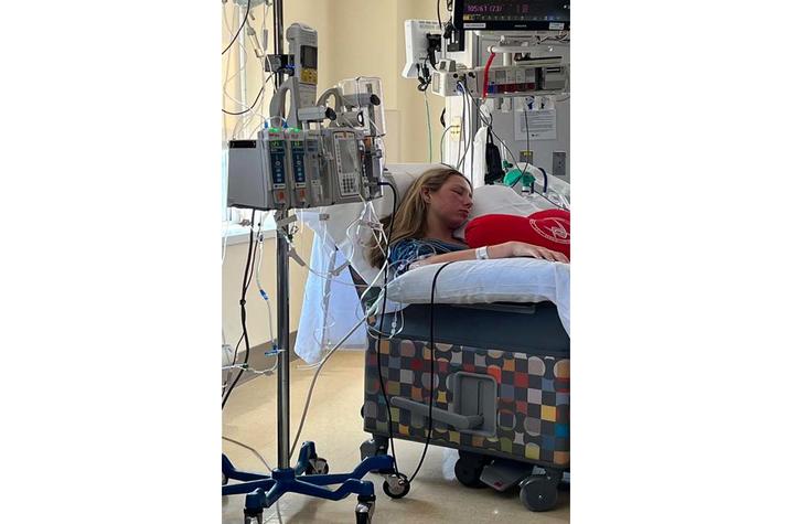 image of Payton in a hospital chair connected to monitors