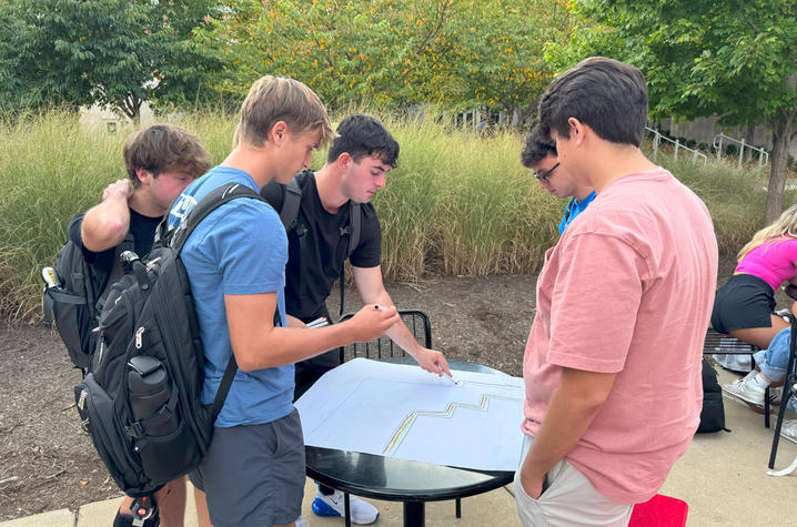 Honors college students planning pollinator garden