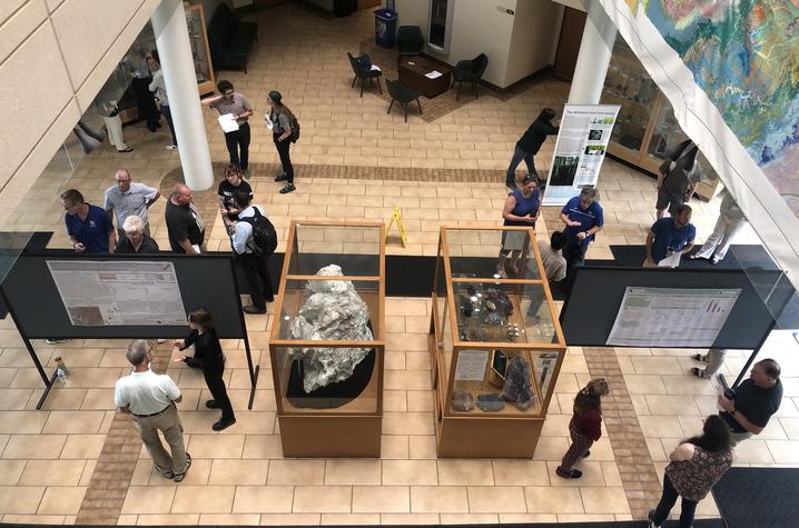 Students, faculty, staff and guests gather in the MMRB atrium to view research posters and chat with interns during the 2024 Potter Internship Showcase. 