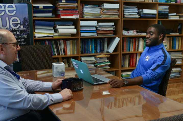 Ralph Crystal with student with laptop at desk