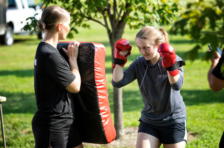 photo of female preparing to punch bag