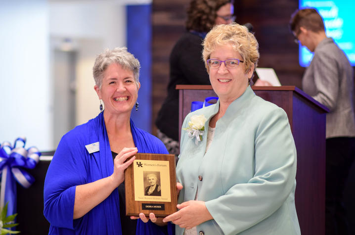 Women's Forum Chair C. Lynn Hiler, left, presents award to Debra Moser.