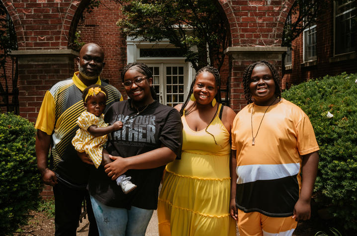 Image of family of four standing outside